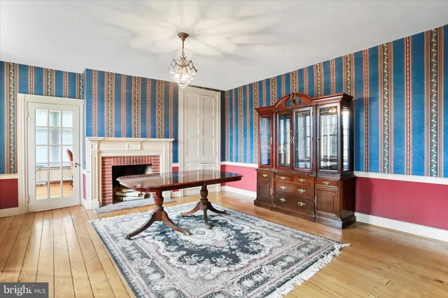 a living room with furniture a fireplace and a chandelier
