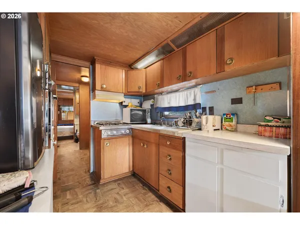 a kitchen with stainless steel appliances granite countertop a refrigerator and a stove