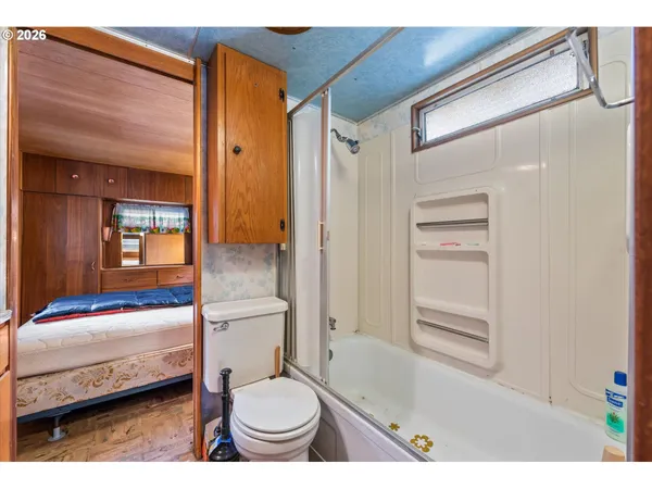 a kitchen view with wooden floor and cabinets