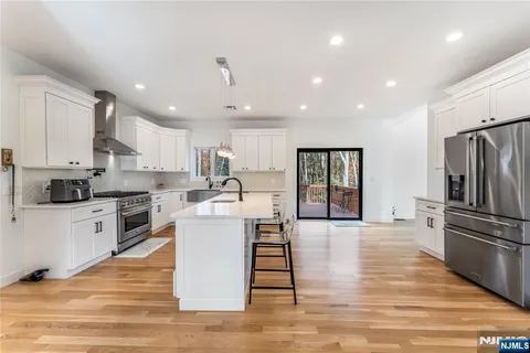 a large kitchen with a table and chairs