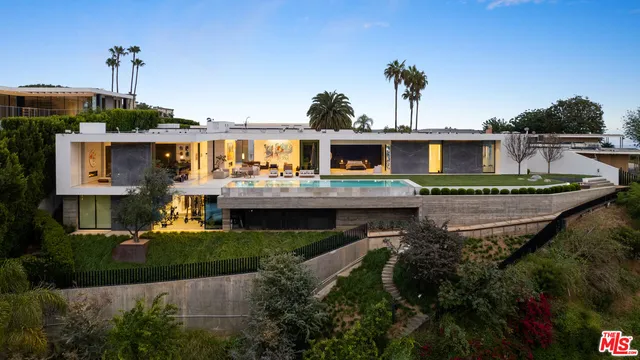a front view of a house with a garden and yard