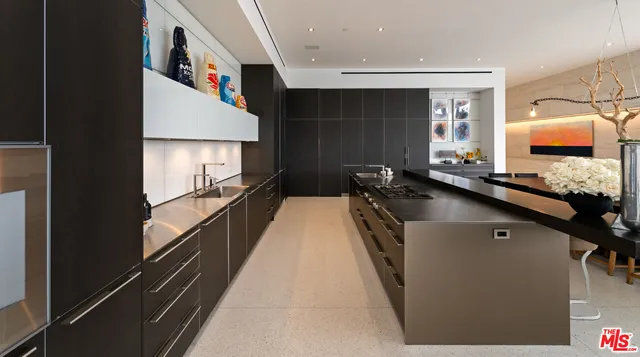 a kitchen with a sink and a stove top oven
