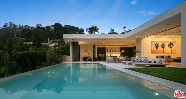 a view of a house with swimming pool and sitting area