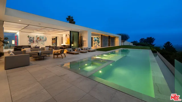 a swimming pool with outdoor seating and yard