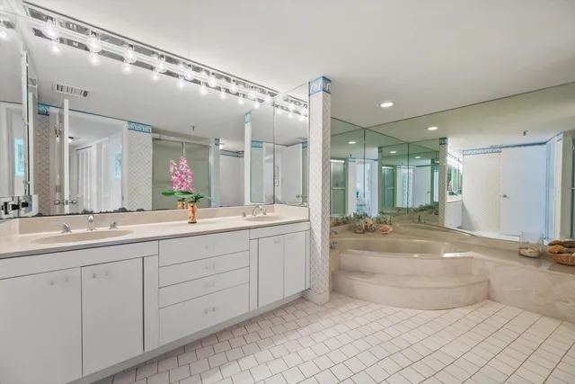 a spacious bathroom with a mirror a double vanity sink and a
