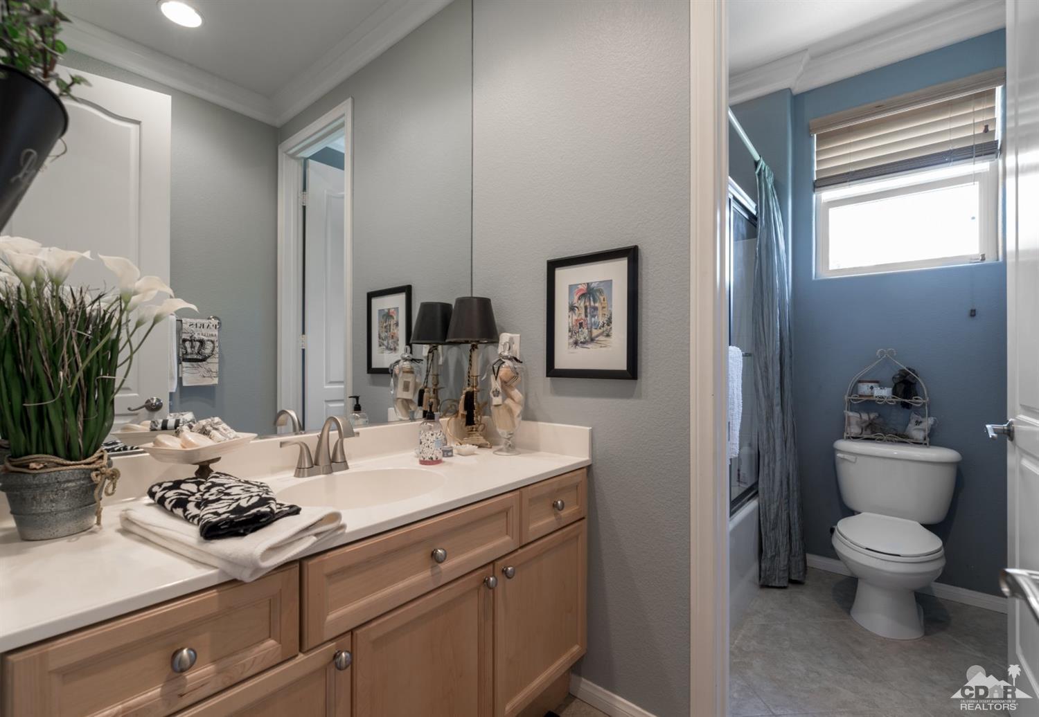 145 Via Solaro Rancho Mirage, CA 92270 - Photo 12 of 40 a bathroom with a granite countertop sink toilet and mirror