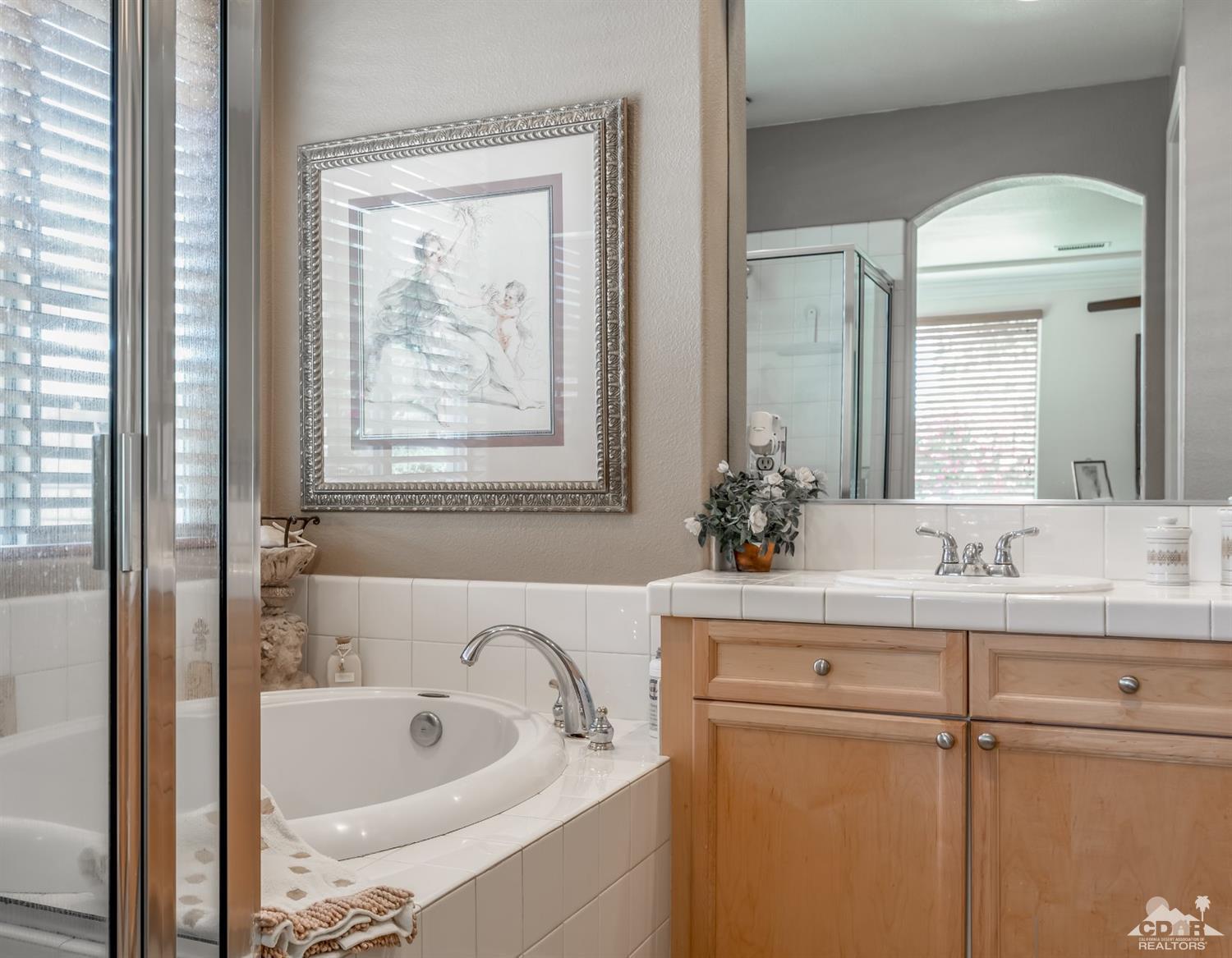145 Via Solaro Rancho Mirage, CA 92270 - Photo 18 of 40 a bathroom with a tub sink and mirror