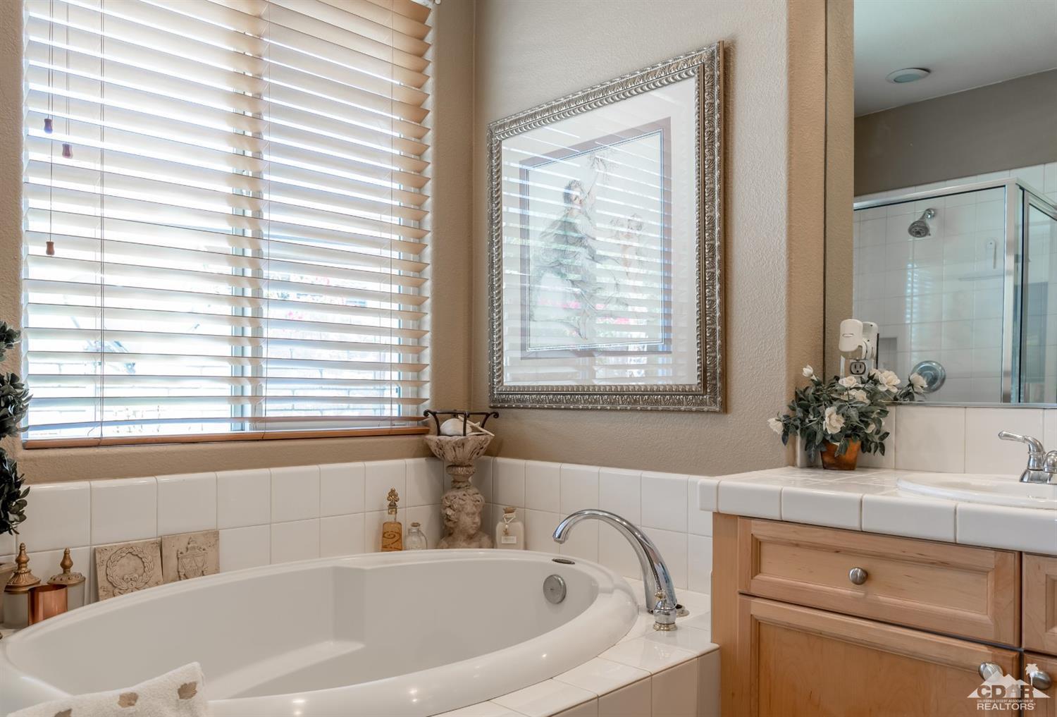 145 Via Solaro Rancho Mirage, CA 92270 - Photo 19 of 40 a bath tub sitting in a bathroom next to a window