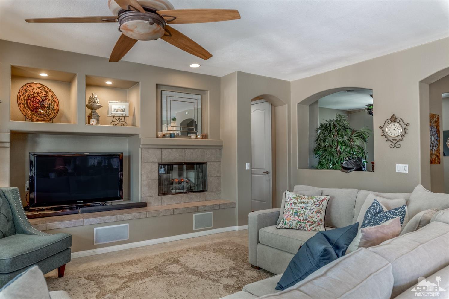 145 Via Solaro Rancho Mirage, CA 92270 - Photo 3 of 40 a living room with furniture and a fireplace