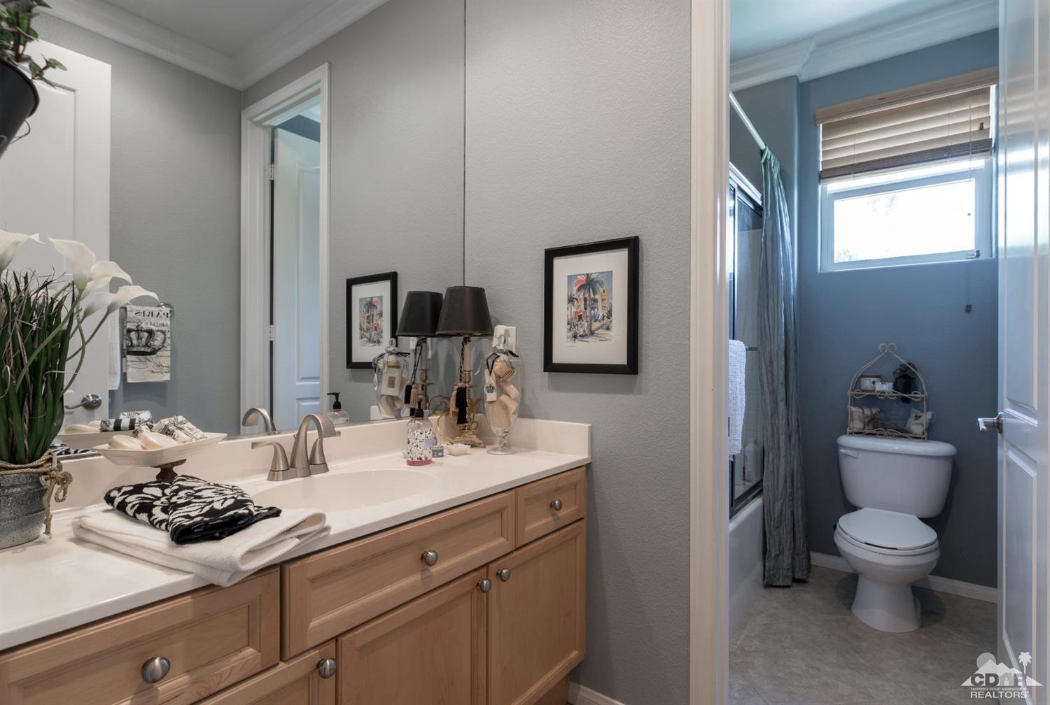 145 Via Solaro Rancho Mirage, CA 92270 - Photo 21 of 40 a bathroom with a sink toilet and mirror