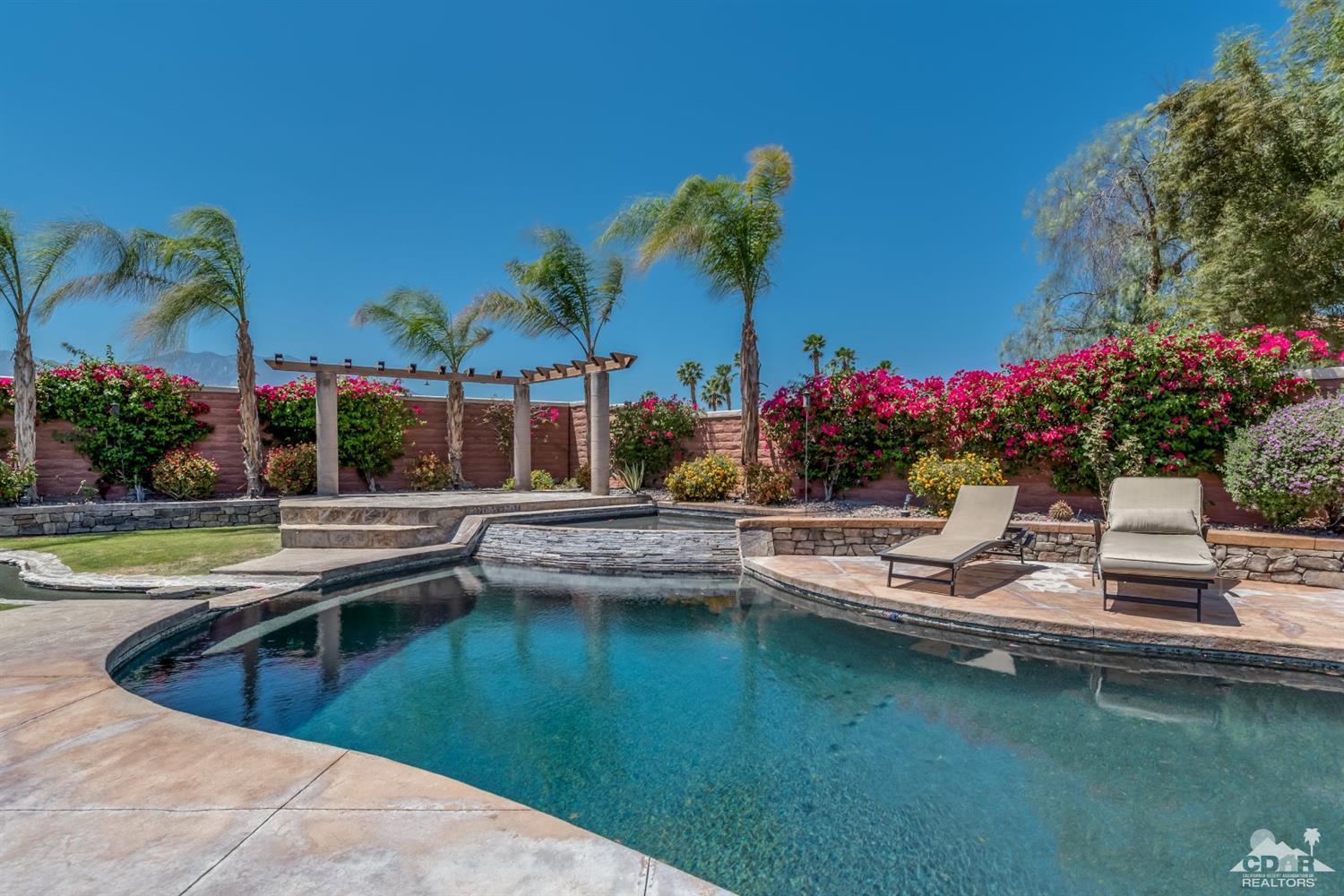 145 Via Solaro Rancho Mirage, CA 92270 - Photo 24 of 40 a view of a house with swimming pool and a garden