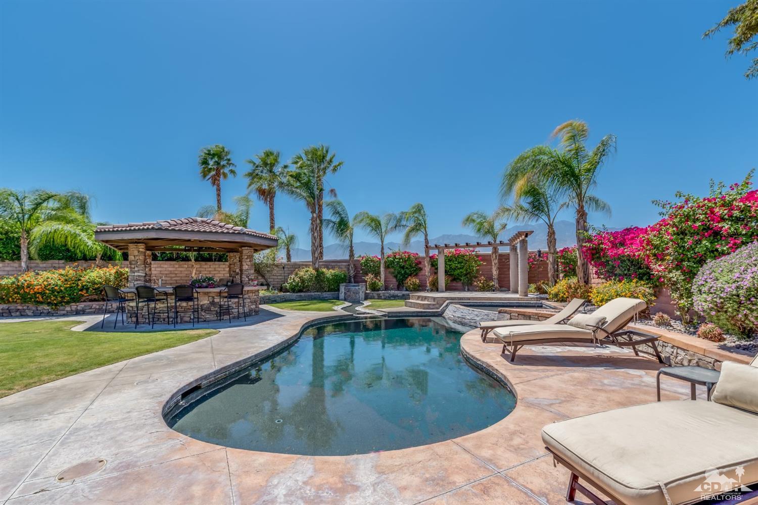 145 Via Solaro Rancho Mirage, CA 92270 - Photo 26 of 40 a view of a house with swimming pool and sitting area