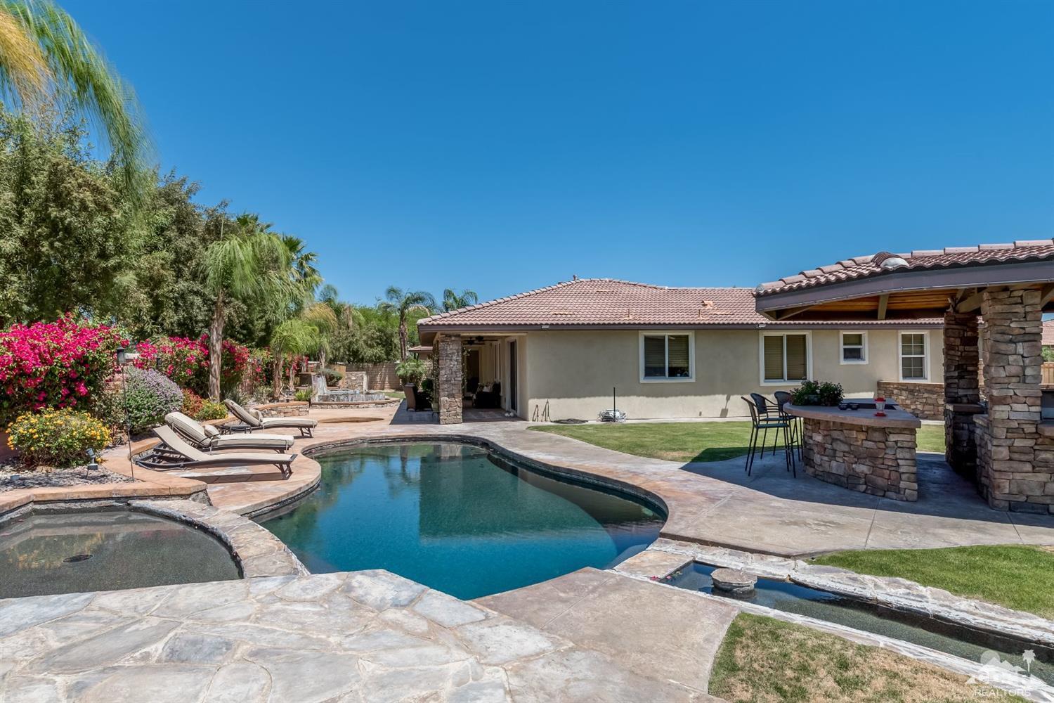 145 Via Solaro Rancho Mirage, CA 92270 - Photo 27 of 40 a view of a house with swimming pool and sitting area