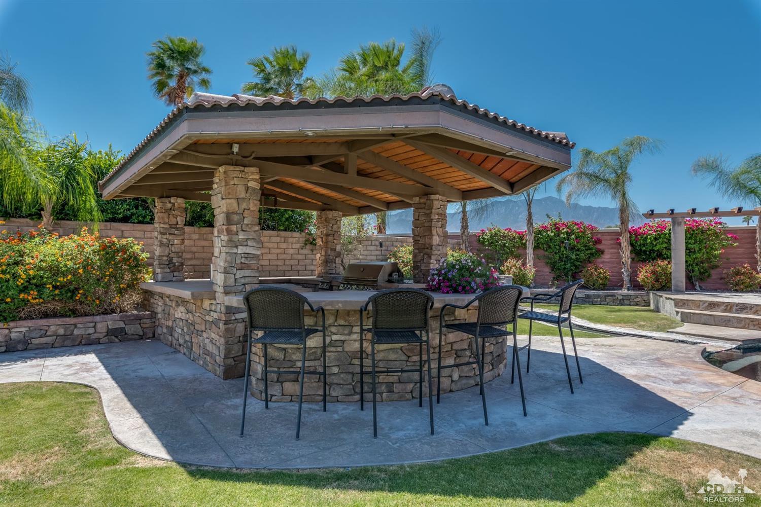 145 Via Solaro Rancho Mirage, CA 92270 - Photo 29 of 40 a table and chairs in front of house