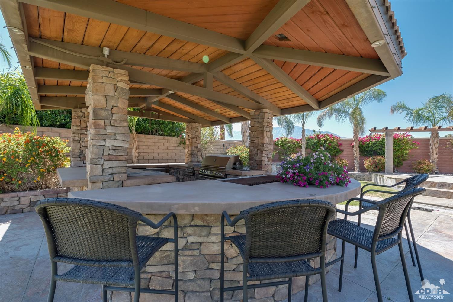 145 Via Solaro Rancho Mirage, CA 92270 - Photo 30 of 40 a patio with a table and chairs