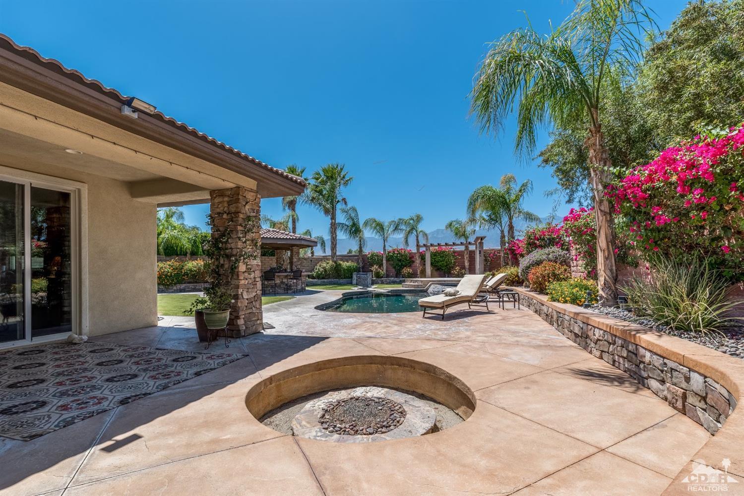 145 Via Solaro Rancho Mirage, CA 92270 - Photo 34 of 40 a view of a backyard with plants and swimming pool