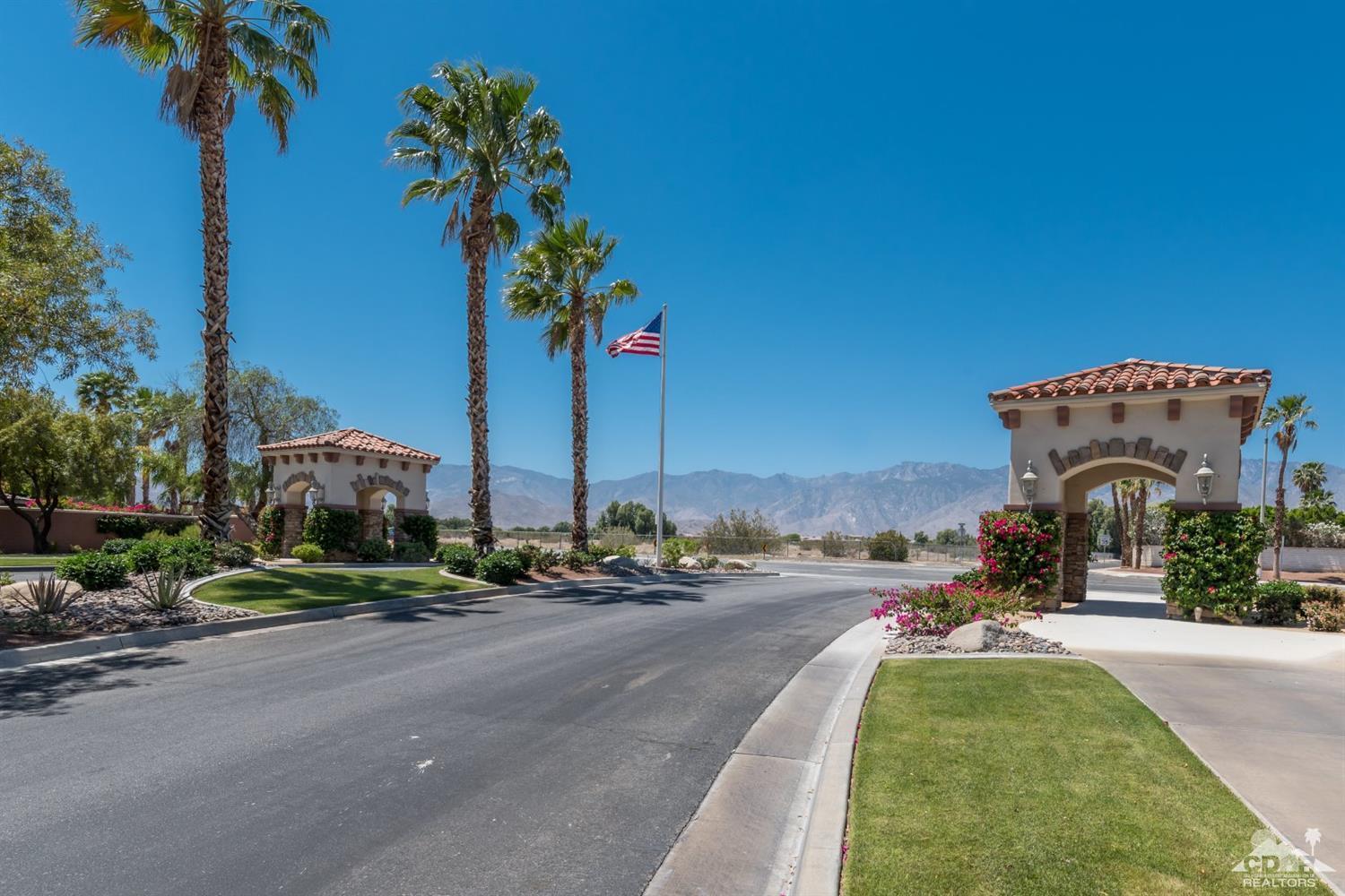 145 Via Solaro Rancho Mirage, CA 92270 - Photo 36 of 40 a front view of a house with a yard and a car park