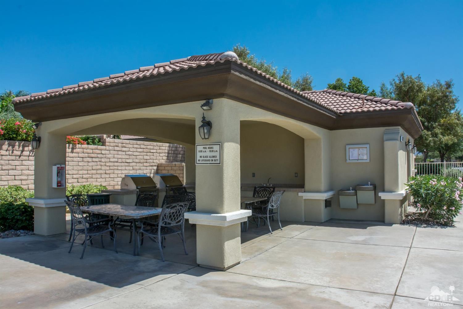 145 Via Solaro Rancho Mirage, CA 92270 - Photo 39 of 40 a view of a patio with table and chairs with potted plants