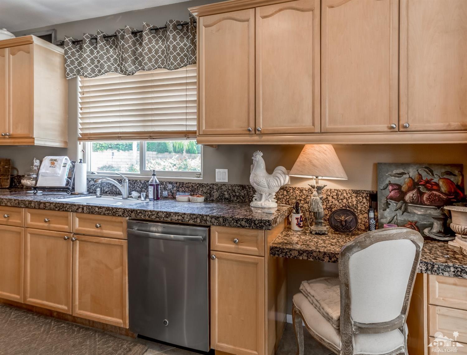 145 Via Solaro Rancho Mirage, CA 92270 - Photo 7 of 40 a kitchen with stainless steel appliances granite countertop a stove a sink and white cabinets