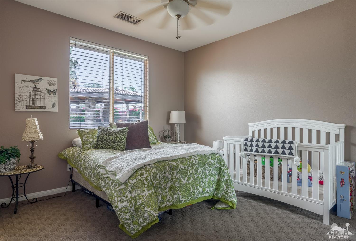 145 Via Solaro Rancho Mirage, CA 92270 - Photo 10 of 40 a bedroom with a bed and a table