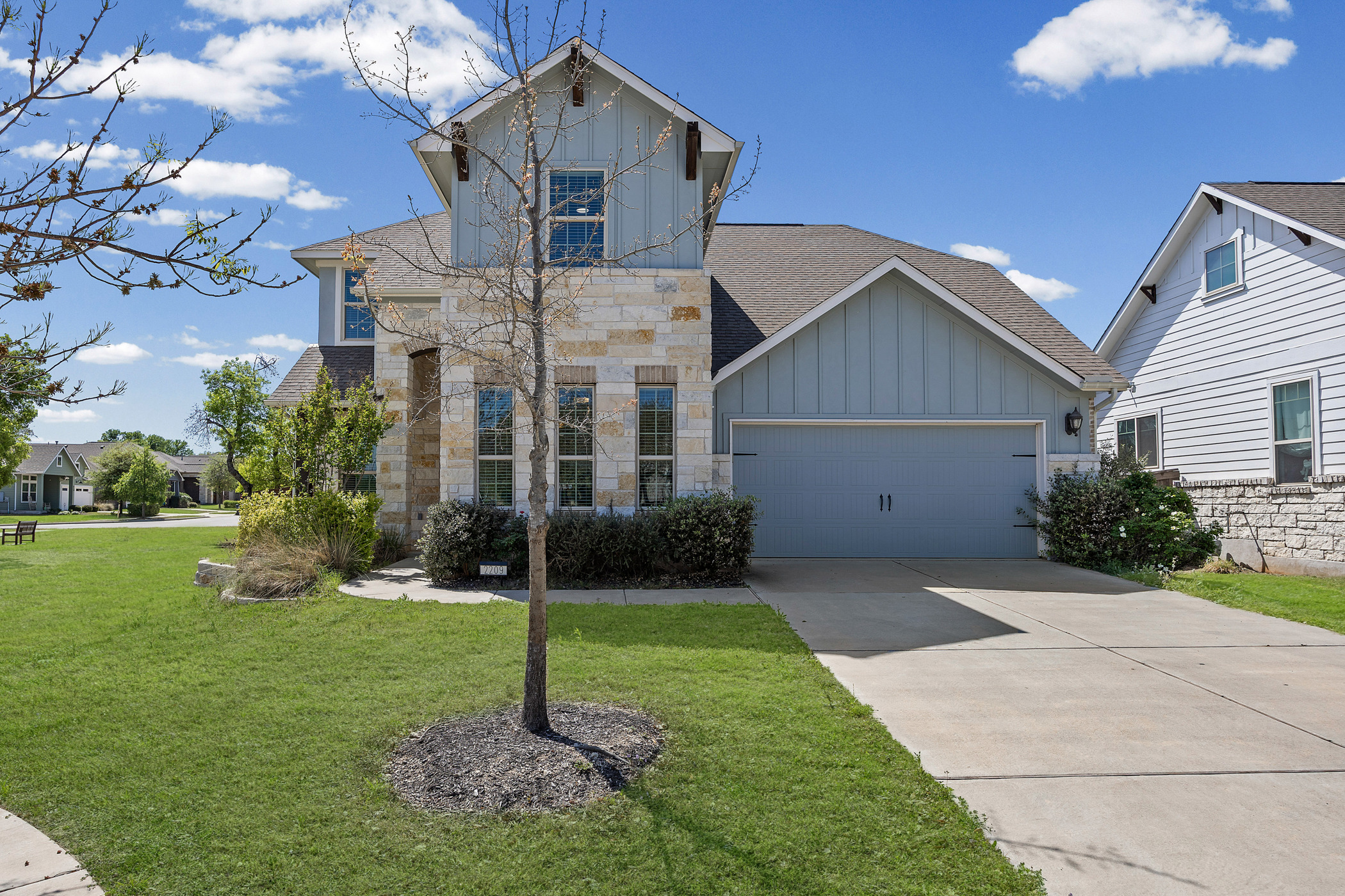 2209 Littleleaf Lane Leander, TX 78641 - Photo 1 of 27 View of front facade featuring board and batten siding, a garage, a front lawn, concrete driveway, and roof with shingles