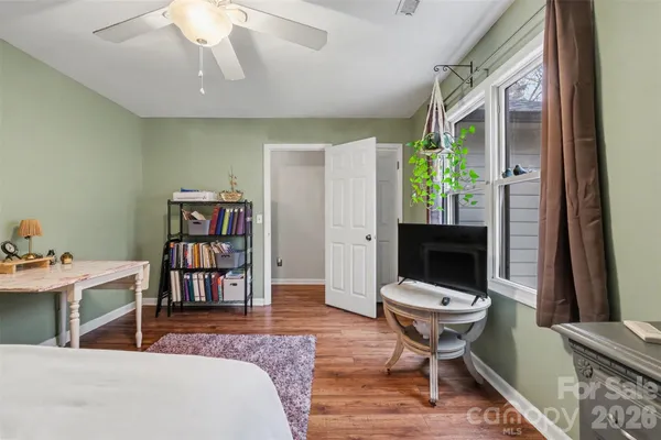 a living room with a piano and a bookshelf
