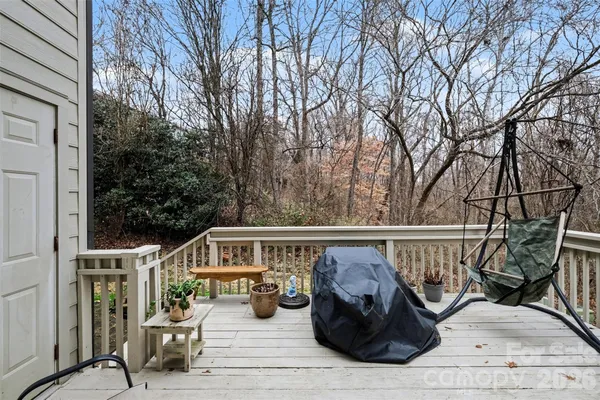 a view of a deck with couches and wooden fence