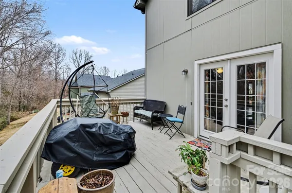 a view of a balcony with chairs and potted plants
