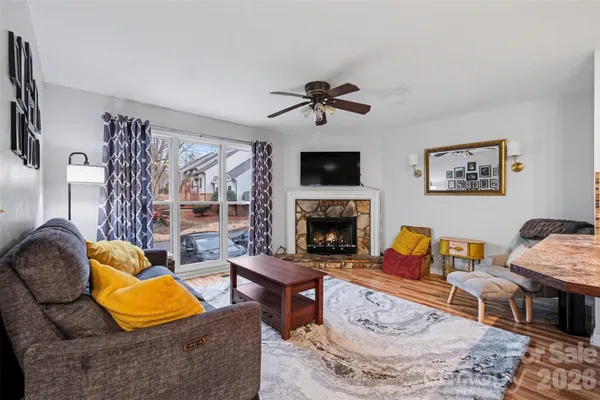 a living room with furniture fireplace and a flat screen tv