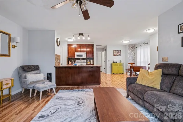 a living room with furniture and a dining area