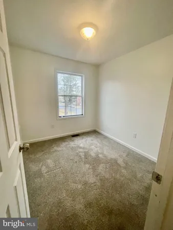 a view of an empty room and a window