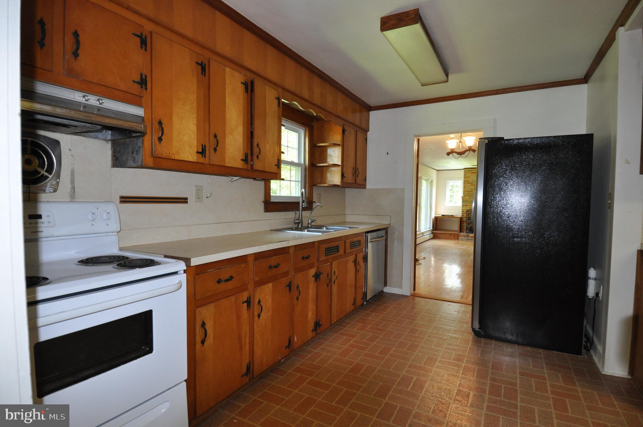 635 Cedar Hall Road Pocomoke City, MD 21851 - Photo 12 of 48 a large kitchen with stainless steel appliances granite countertop a stove a sink and a refrigerator