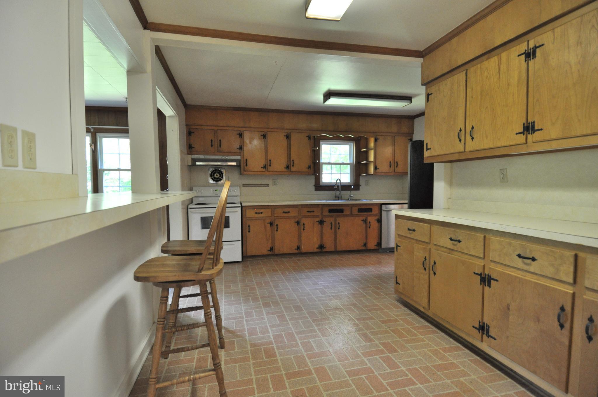 635 Cedar Hall Road Pocomoke City, MD 21851 - Photo 14 of 48 a kitchen with granite countertop a sink cabinets and stainless steel appliances
