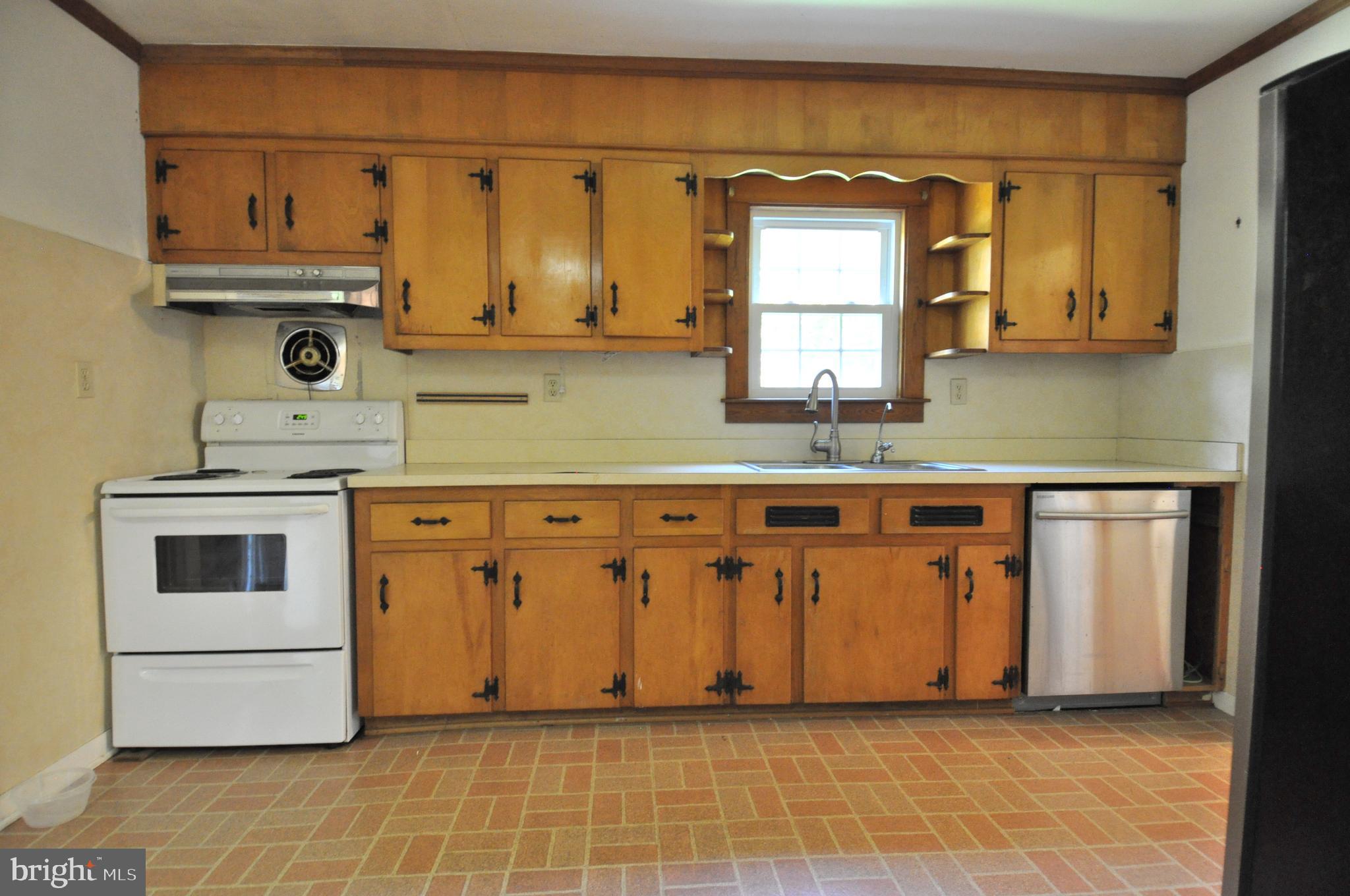 635 Cedar Hall Road Pocomoke City, MD 21851 - Photo 16 of 48 a kitchen with stainless steel appliances granite countertop a stove a sink and a microwave