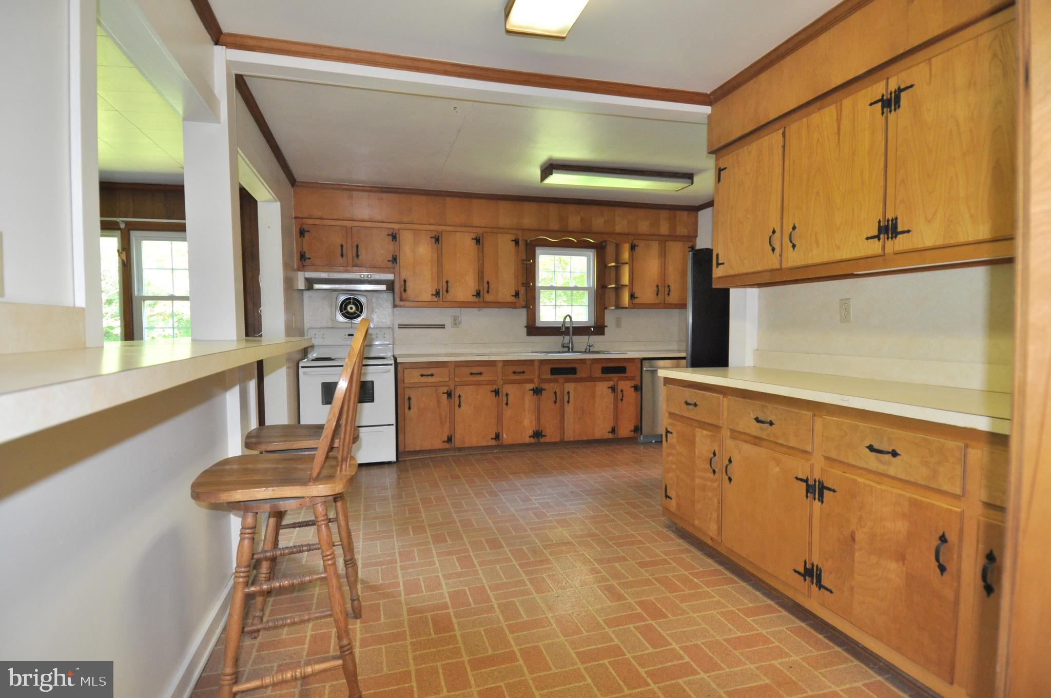 635 Cedar Hall Road Pocomoke City, MD 21851 - Photo 17 of 48 a kitchen with granite countertop a stove a sink and a refrigerator