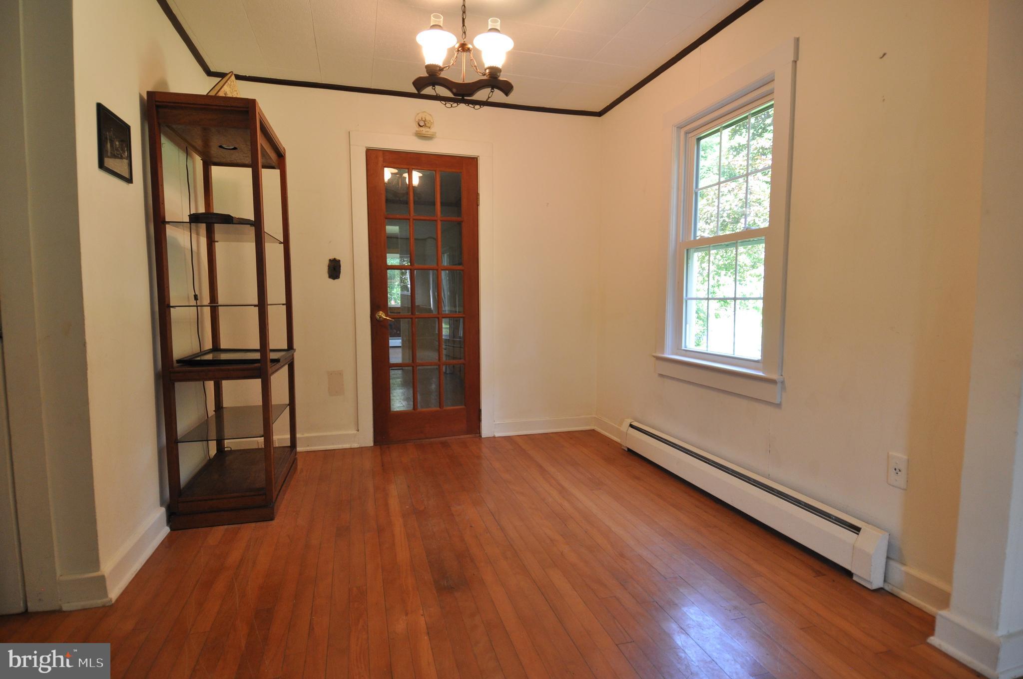 635 Cedar Hall Road Pocomoke City, MD 21851 - Photo 18 of 48 a view of an empty room with window and wooden floor