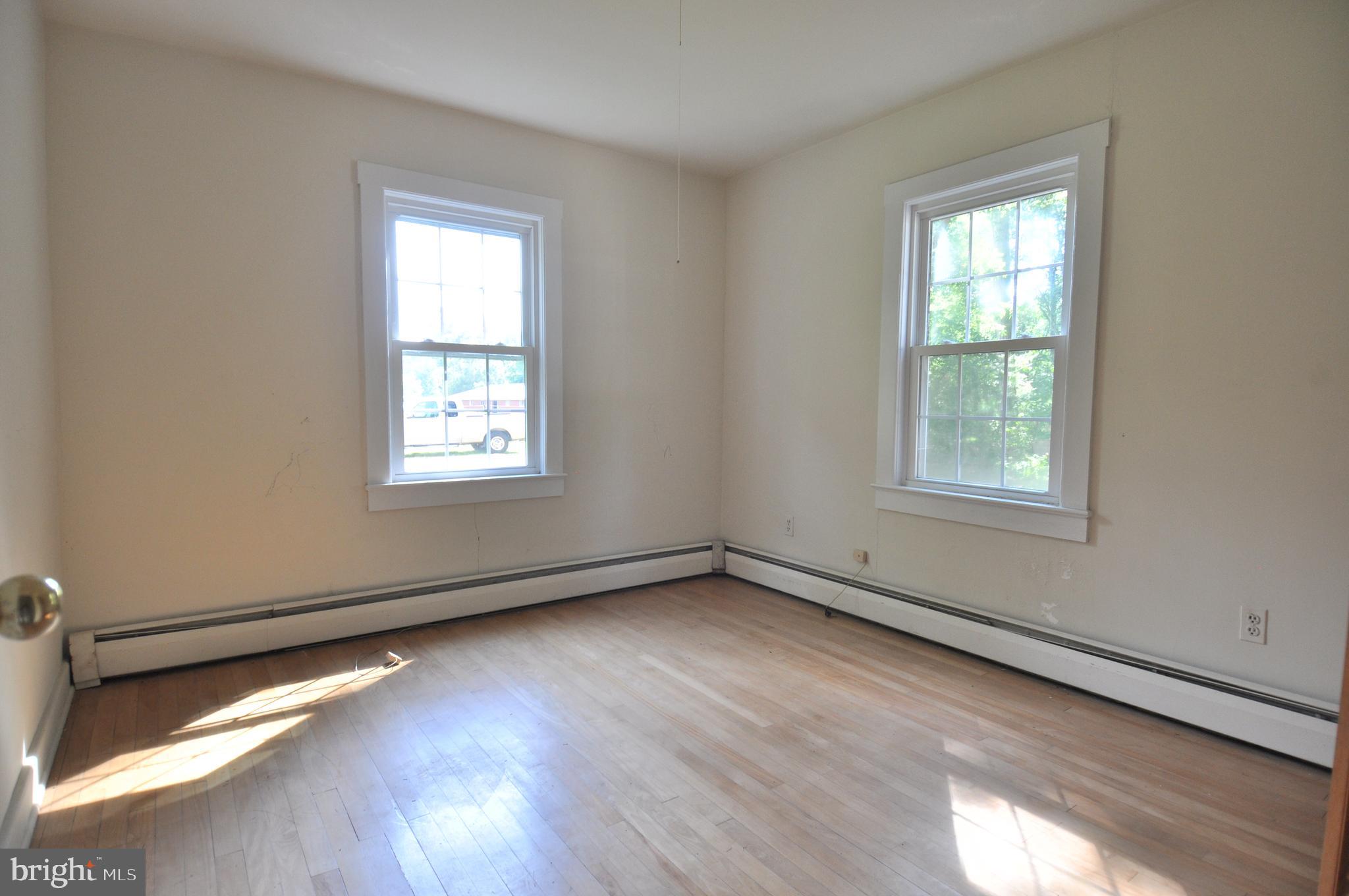 635 Cedar Hall Road Pocomoke City, MD 21851 - Photo 31 of 48 an empty room with wooden floor and windows