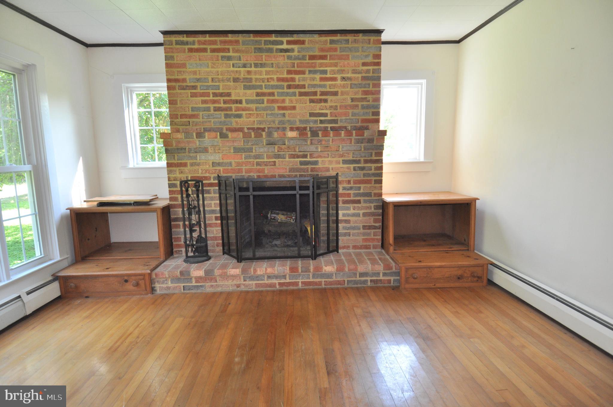 635 Cedar Hall Road Pocomoke City, MD 21851 - Photo 7 of 48 a living room with furniture and a fireplace