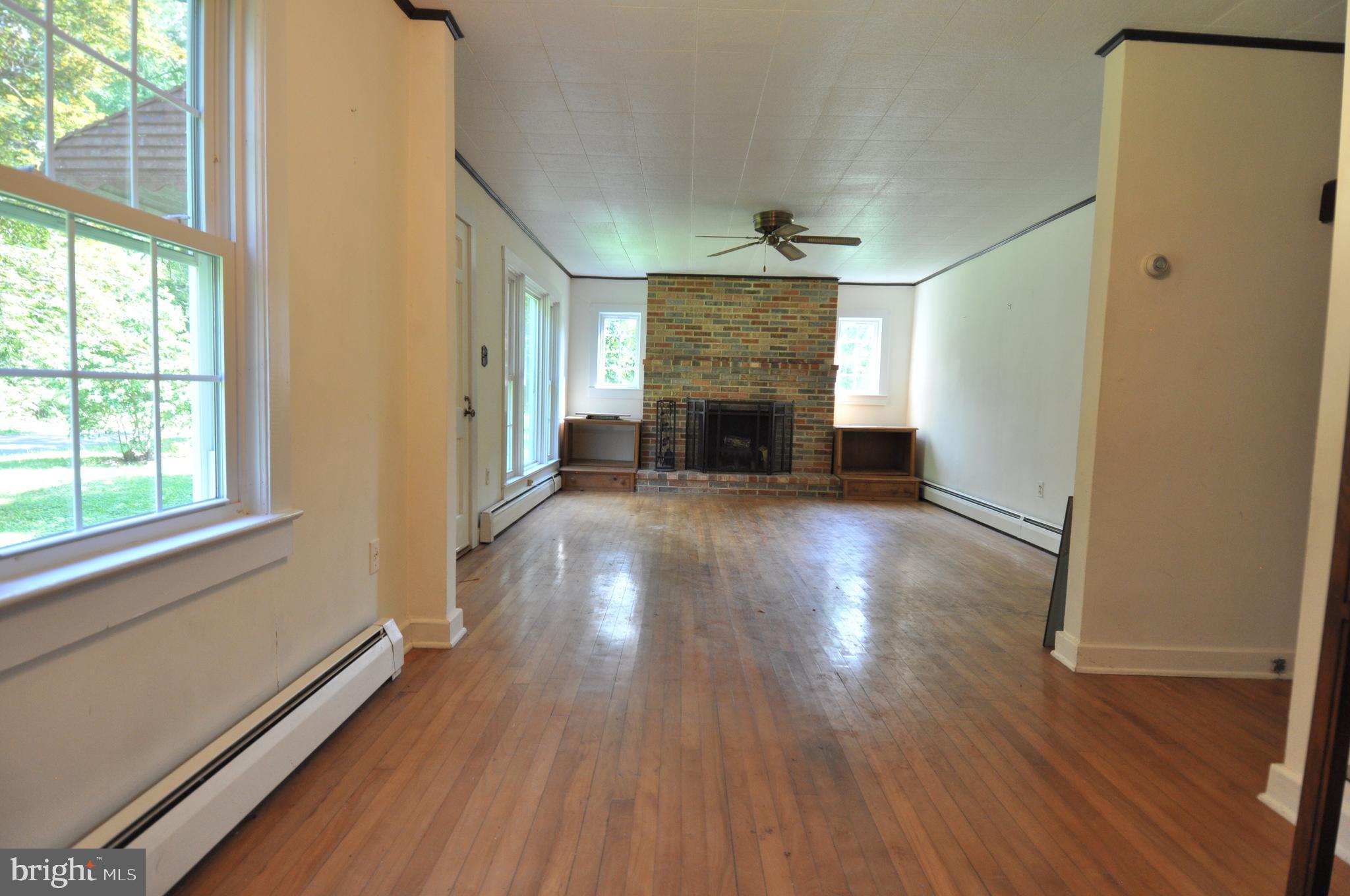 635 Cedar Hall Road Pocomoke City, MD 21851 - Photo 8 of 48 a view of empty room with wooden floor and fireplace