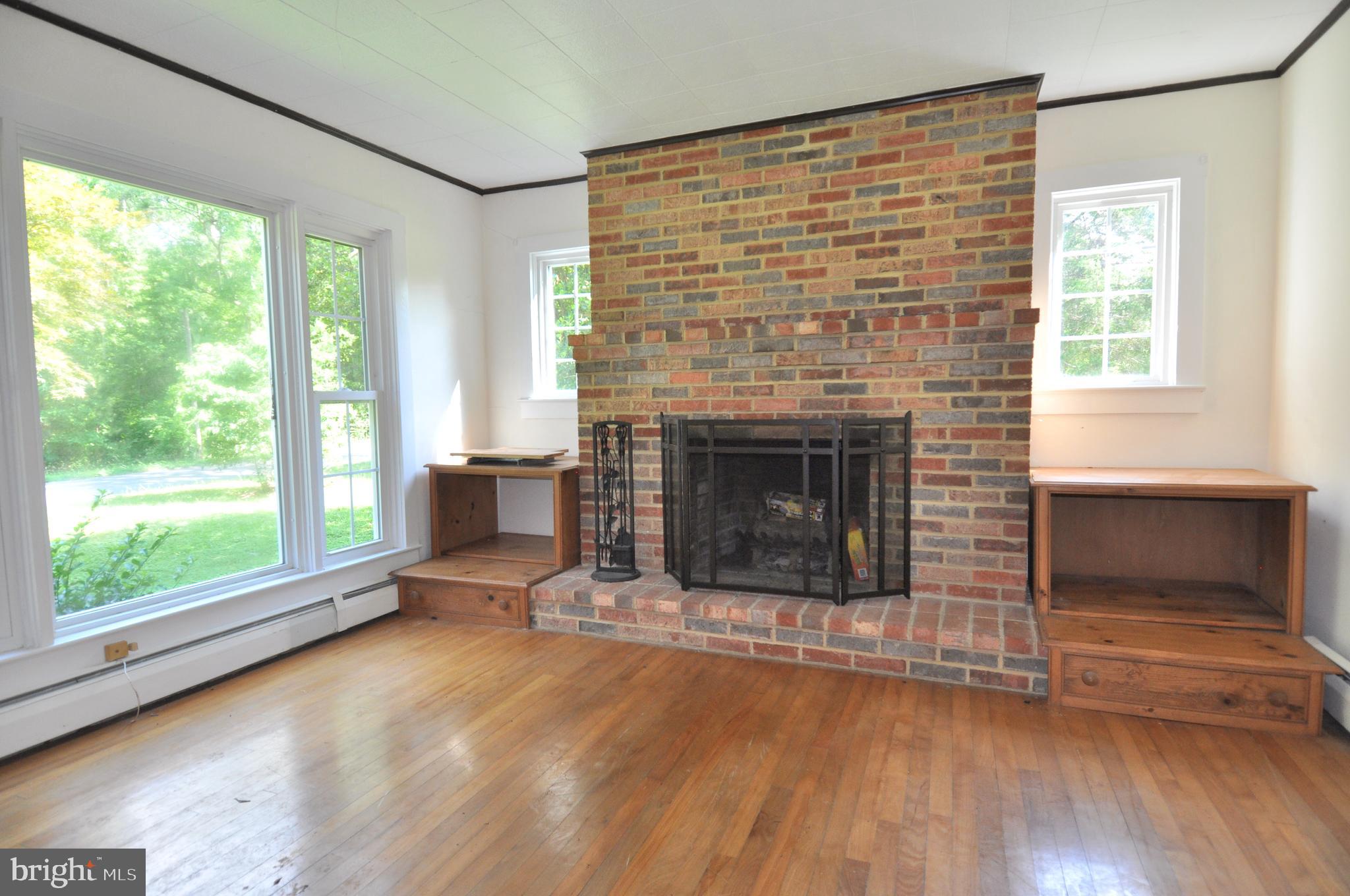 635 Cedar Hall Road Pocomoke City, MD 21851 - Photo 9 of 48 a living room with a fireplace and windows