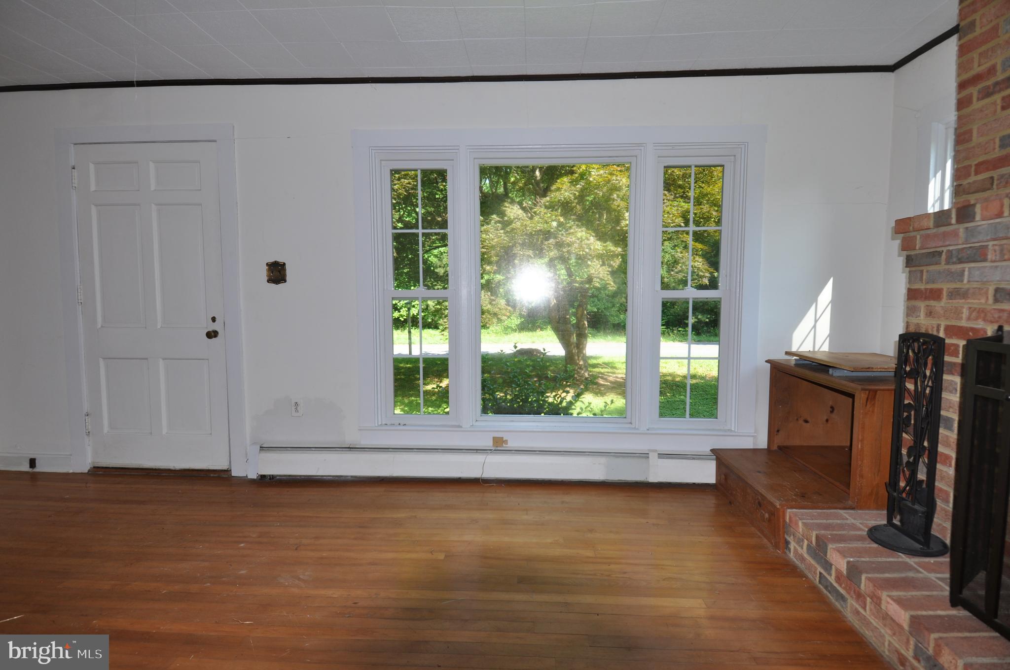 635 Cedar Hall Road Pocomoke City, MD 21851 - Photo 10 of 48 a view of a room that has a fireplace in it