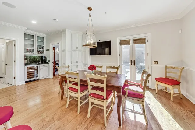 a view of a dining room with furniture a rug and wooden floor