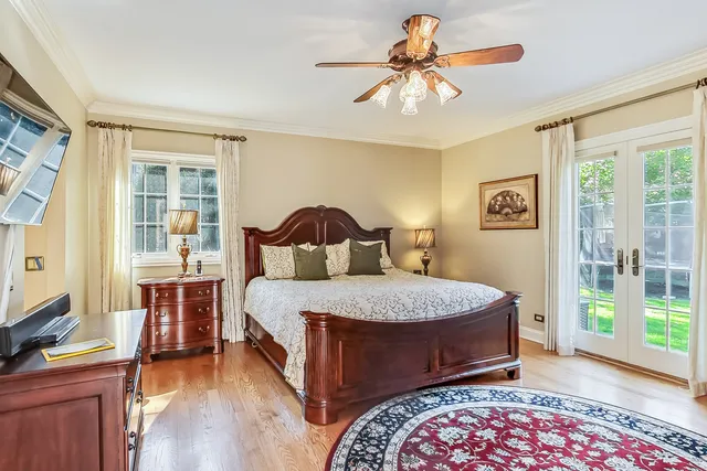 a bedroom with a bed and a chandelier