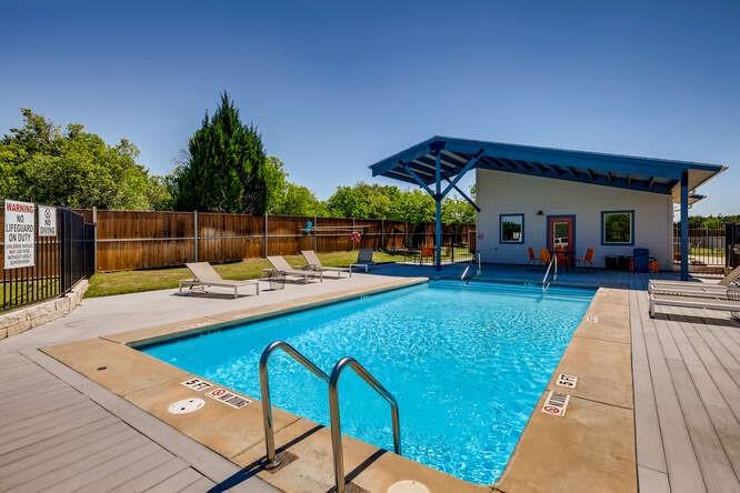 7805 Cooper Lane, Unit 206 Austin, TX 78745 - Photo 12 of 13 Lounge in the community pool, surrounded by a wood fence and a shaded cabana for ultimate relaxation.