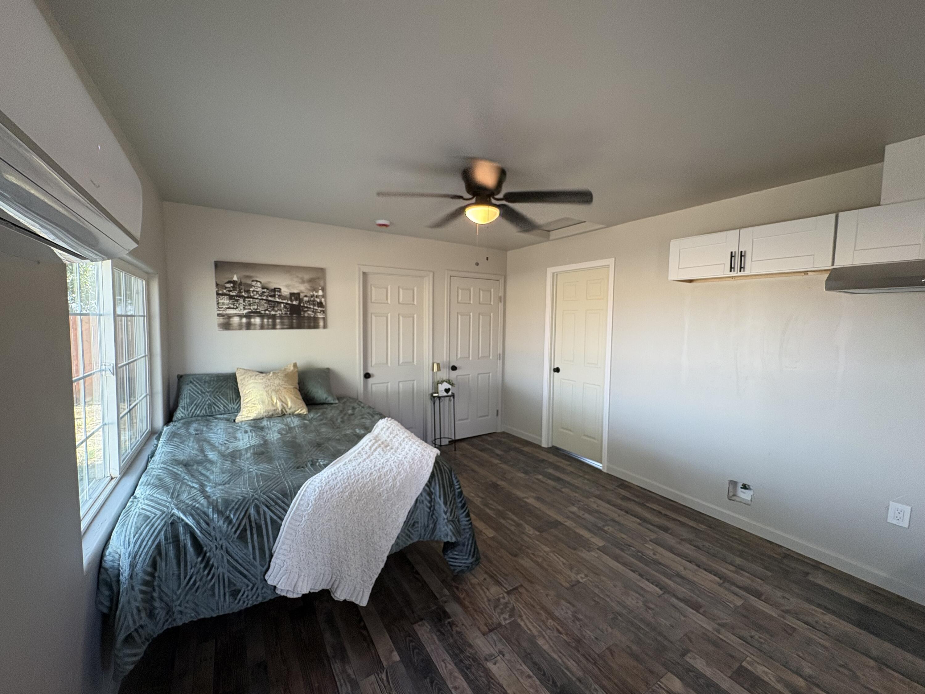 177 South Callison Road Tipton, CA 93272 - Photo 13 of 18 a spacious bedroom with a bed and a chandelier