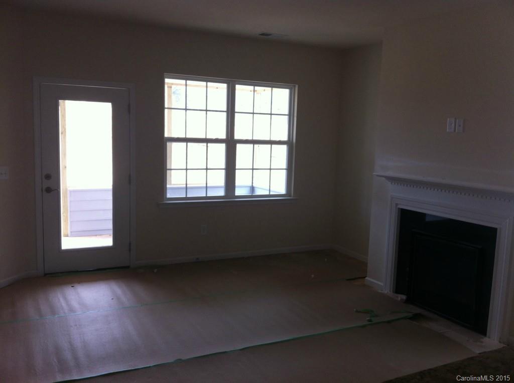 4250 Perth Road, Unit 307 Indian Land, SC 29707 - Photo 5 of 12 an empty room with a fireplace