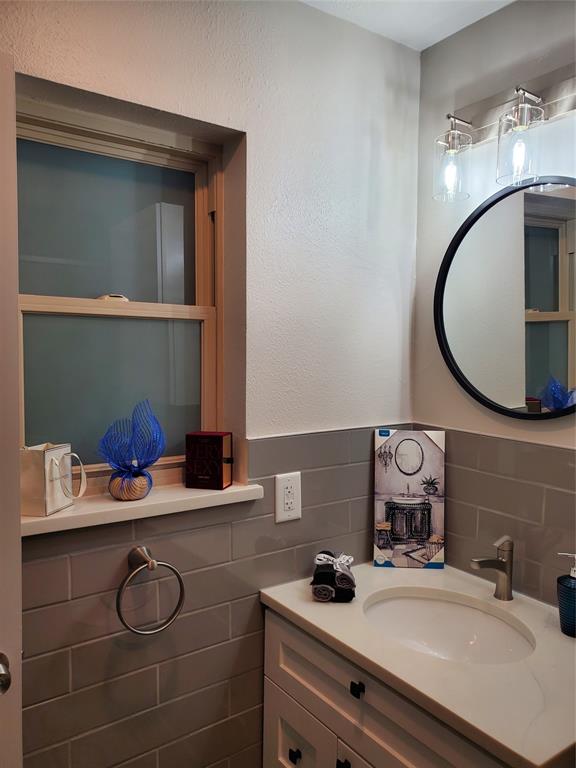 7424 Walling Lane Dallas, TX 75231 - Photo 11 of 19 a bathroom with a sink and a mirror