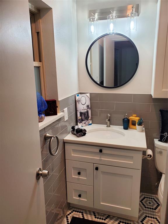 7424 Walling Lane Dallas, TX 75231 - Photo 12 of 19 a bathroom with a sink mirror and vanity