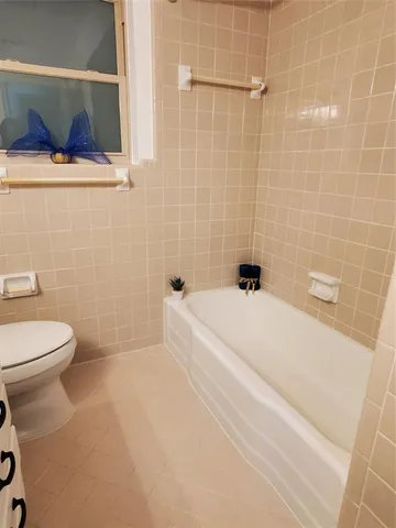 a white bath tub sitting next to a white toilet