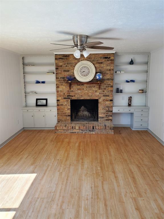 7424 Walling Lane Dallas, TX 75231 - Photo 2 of 19 a living room with furniture and a fireplace